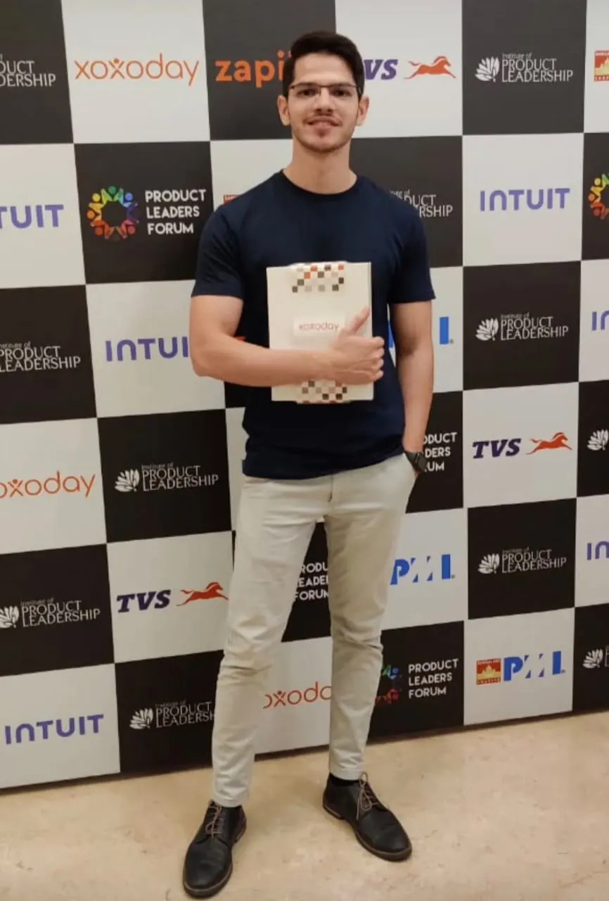 Mohammed Mudassir holding the award at Product Leaders Forum 2023